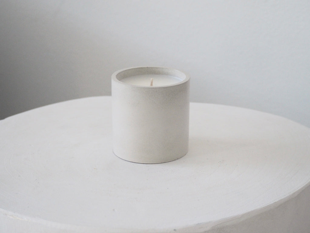Makana concrete candle on rustic white stool