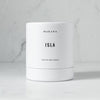A white jar with the word Isla - Classic Candle by Makana on it featuring tiare gardenia and island foliage design.